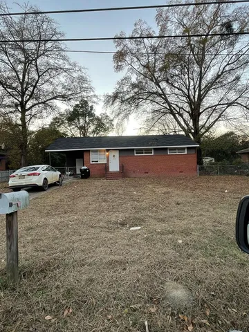 a view of house with car parked