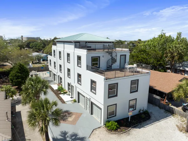 an aerial view of a house with a yard