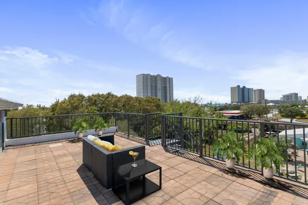 a living room with stainless steel appliances kitchen island granite countertop furniture and a kitchen view