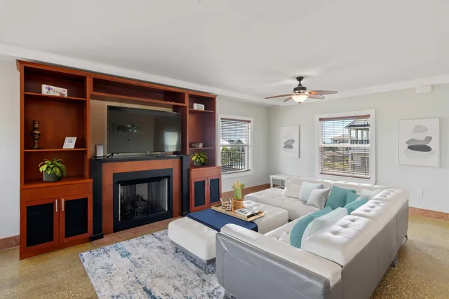 a living room with furniture dining area and a window