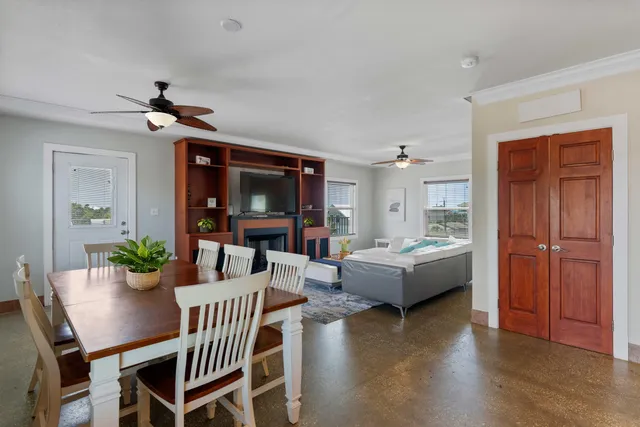 a dining room with furniture and a window