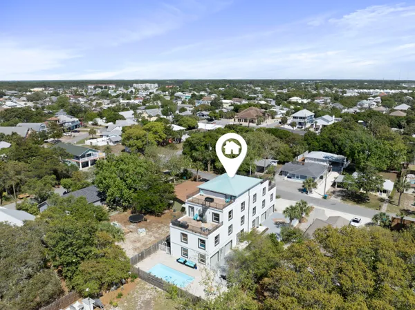an aerial view of a house with yard