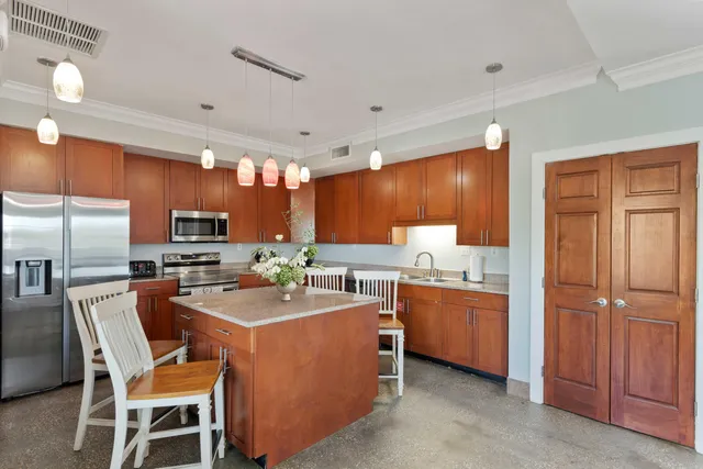a view of a roof deck with couches and wooden fence