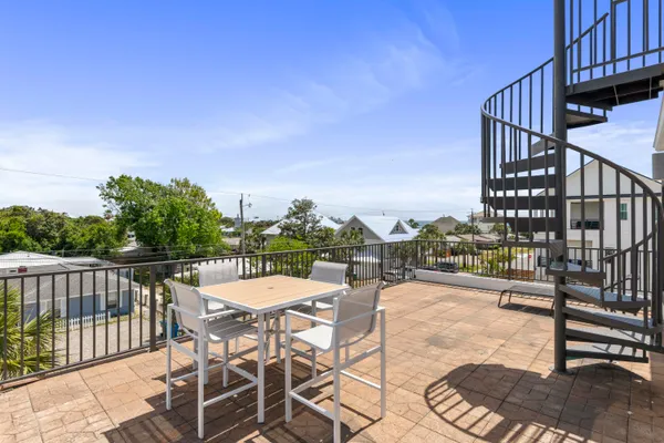 a view of a balcony with two chairs and a table
