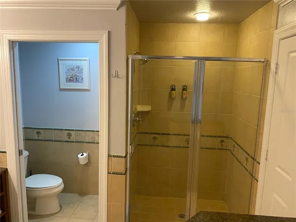 a bathroom with a toilet and a shower