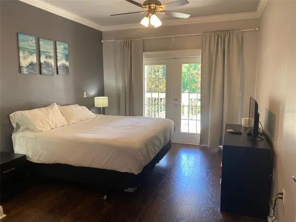 a large bed sitting in a bedroom next to a window