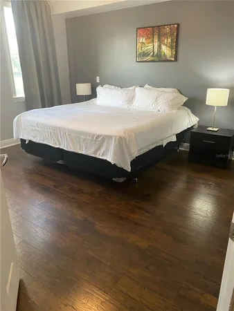 a bedroom with a bed and lamps