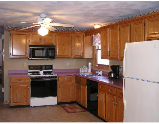 32 Moran Road Billerica, MA 01862 - Photo 9 of 18 a kitchen with stainless steel appliances granite countertop a refrigerator a sink dishwasher a stove top oven a kitchen island and cabinetry