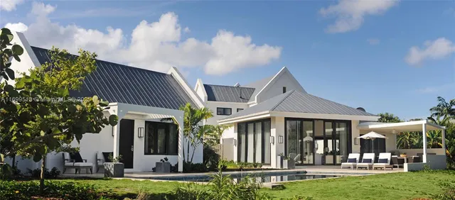 a front view of a house with yard porch and furniture