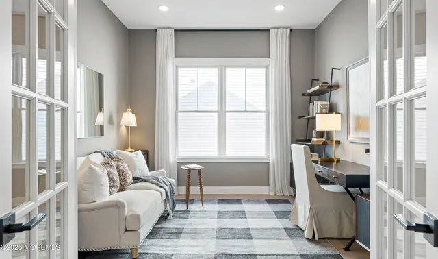 a kitchen with stainless steel appliances kitchen island granite countertop a table chairs and a refrigerator