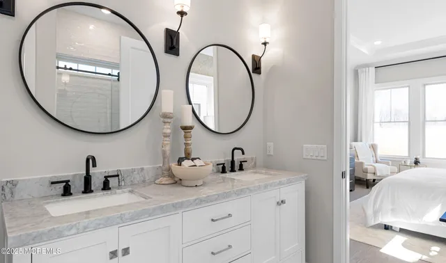 a bedroom with a large bed and a flat tv screen on dresser