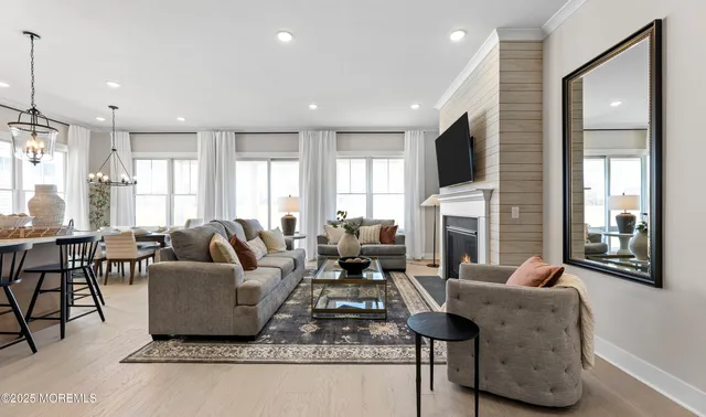 a living room with furniture fireplace and flat screen tv