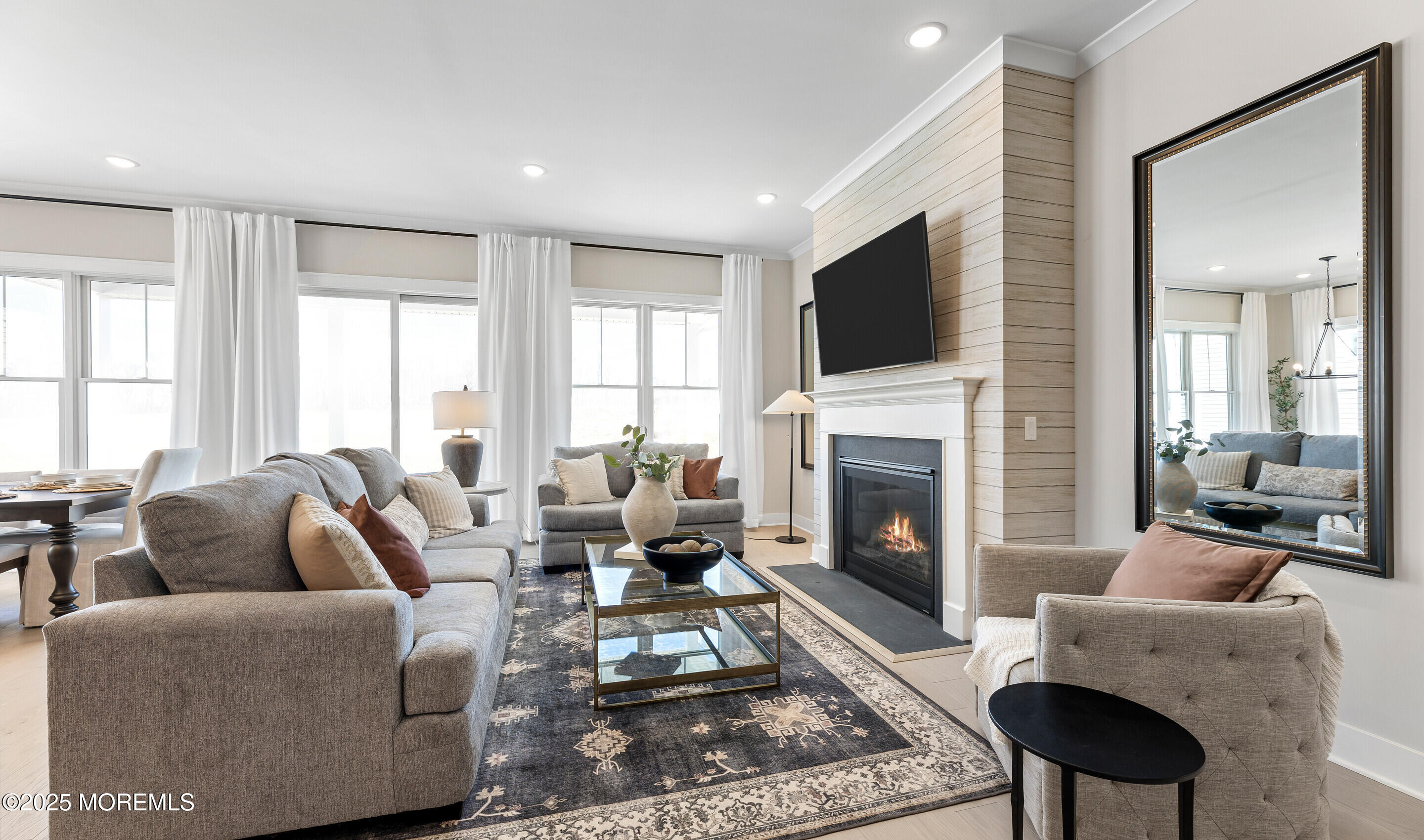 176 Highway 33, Unit DORCHESTER LOFT Manalapan, NJ 07726 - Photo 9 of 38 a living room with furniture fireplace and flat screen tv
