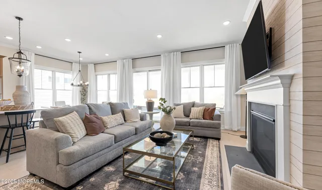 a living room with furniture a dining table and a window