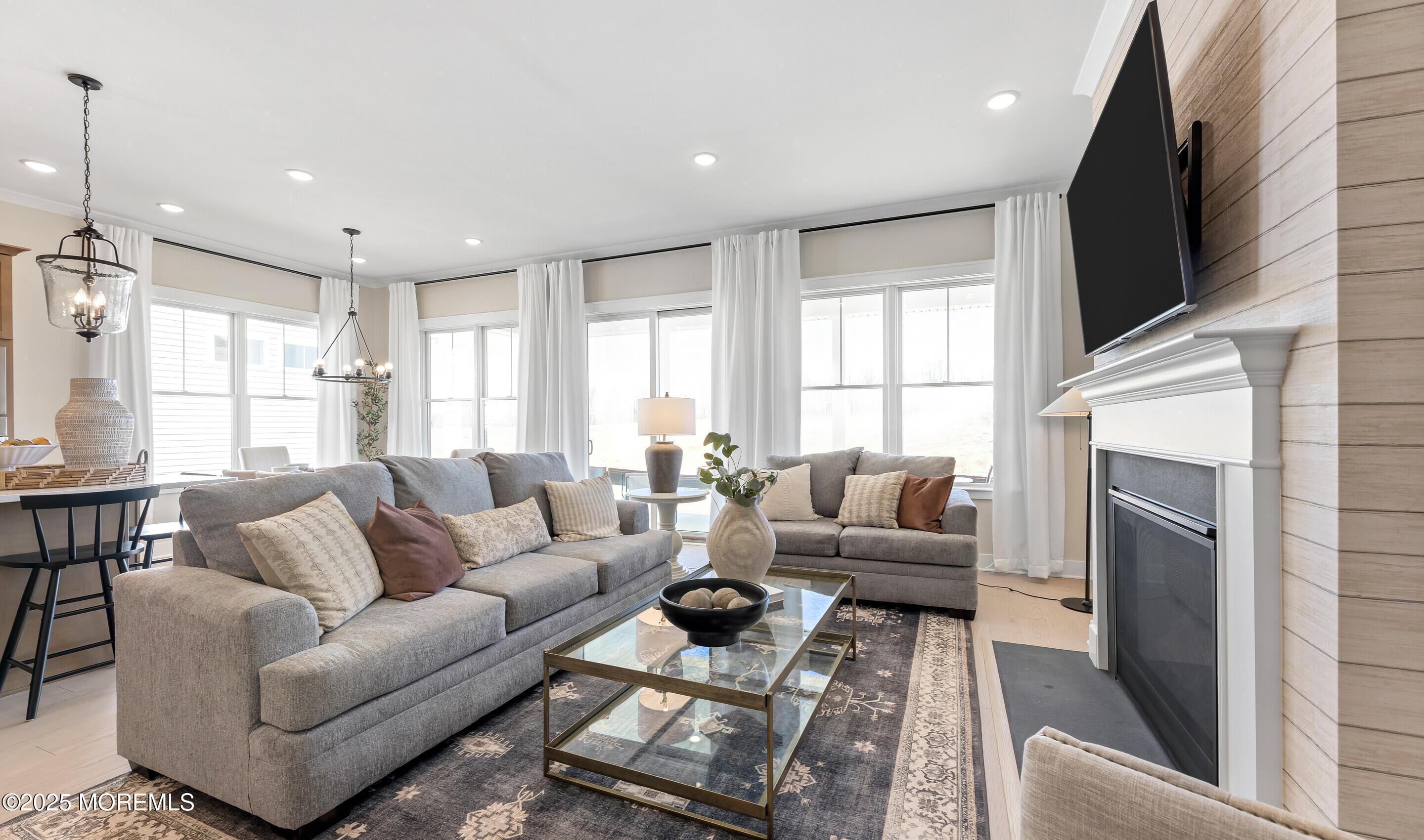 176 Highway 33, Unit DORCHESTER LOFT Manalapan, NJ 07726 - Photo 10 of 38 a living room with furniture a flat screen tv and a fireplace