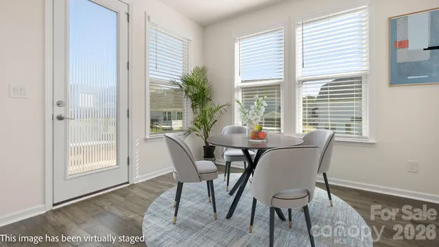 a view of a dining room with furniture and windows