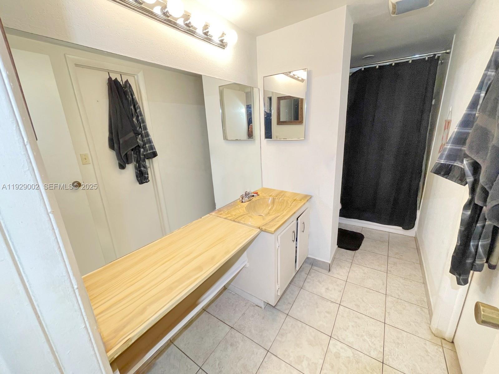 2800 Northwest 56th Avenue, Unit E103 Lauderhill, FL 33313 - Photo 6 of 15 a bathroom with a tub and sink