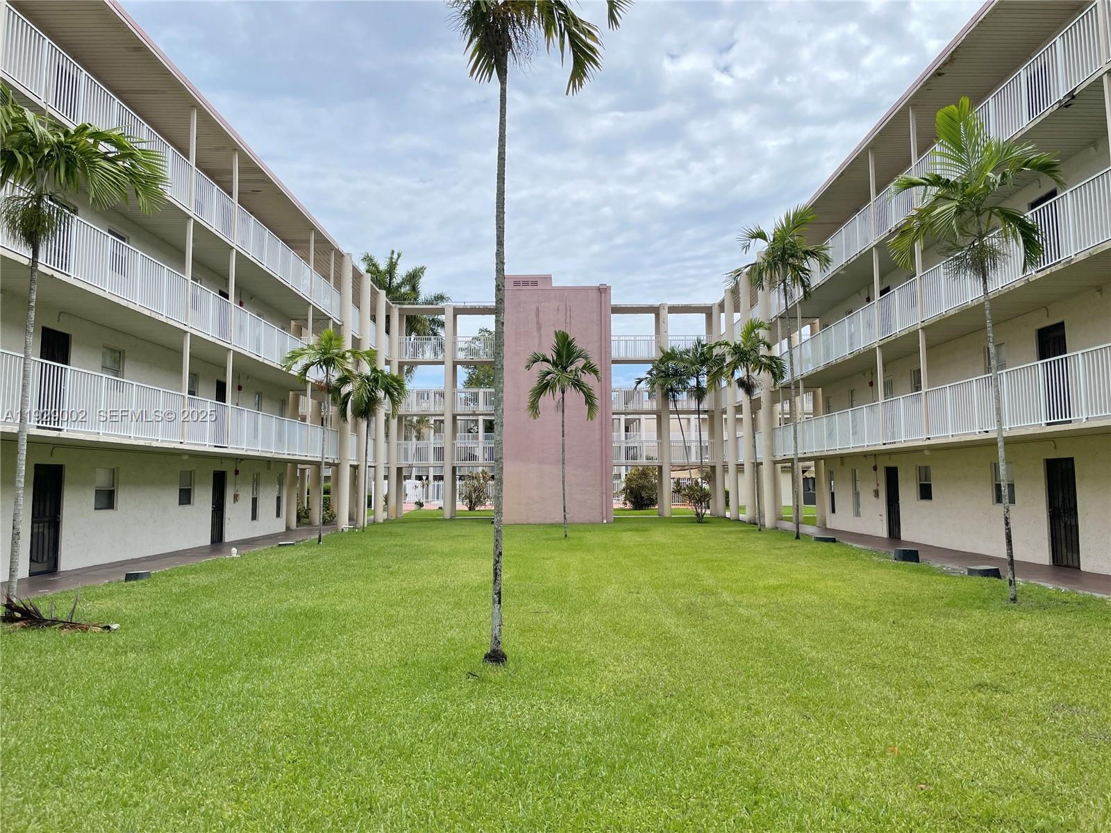 2800 Northwest 56th Avenue, Unit E103 Lauderhill, FL 33313 - Photo 9 of 15 a garden view with a building in the background
