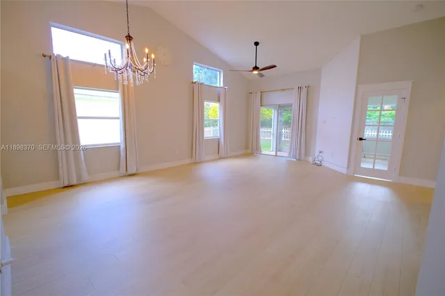 a living room with furniture a chandelier and a chandelier