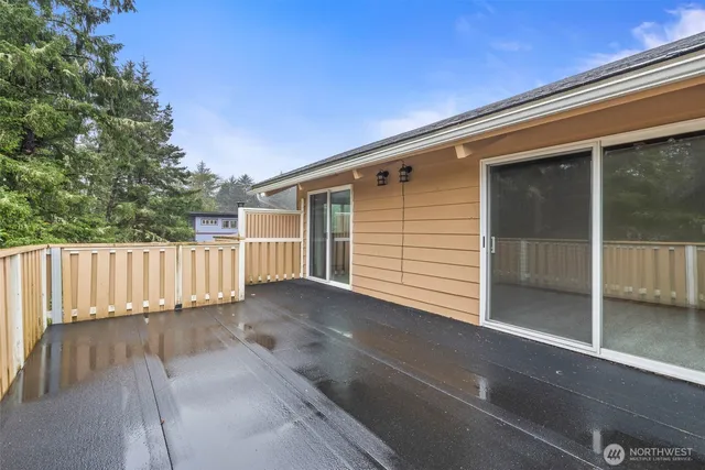 a view of a house with a wooden fence