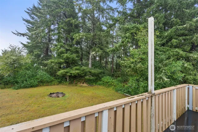 a view of a green field with wooden fence