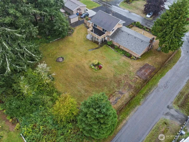 an aerial view of residential house with yard