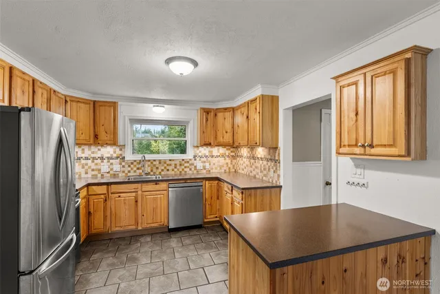 a kitchen with stainless steel appliances granite countertop a refrigerator sink and cabinets