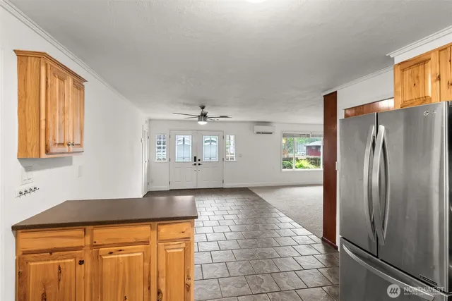 a view of a refrigerator in kitchen and wooden floor