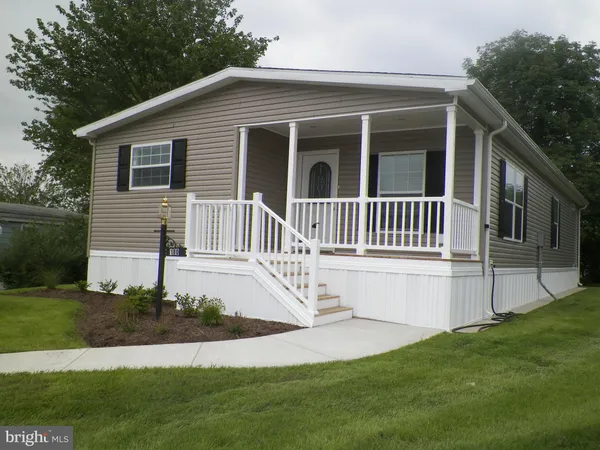 a view of a house with a yard and deck