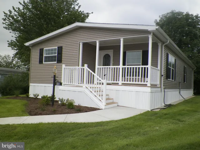 a view of a house with a yard and deck