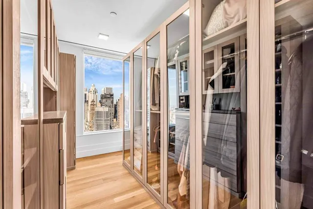 a bathroom with a double vanity sink a mirror and a bathtub