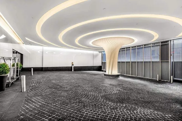 a living room with furniture and large windows