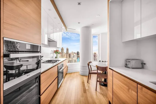 a dining room with furniture window and wooden floor