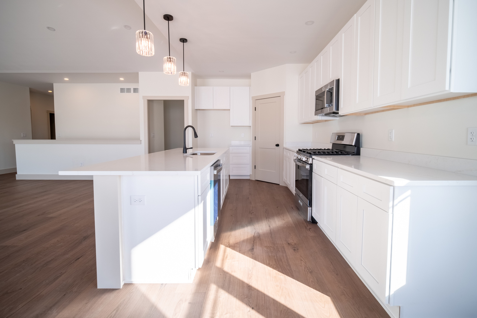 550 Cross Plains Road Rockford, IL 61107 - Photo 11 of 34 a kitchen with a sink a stove a refrigerator and white cabinets