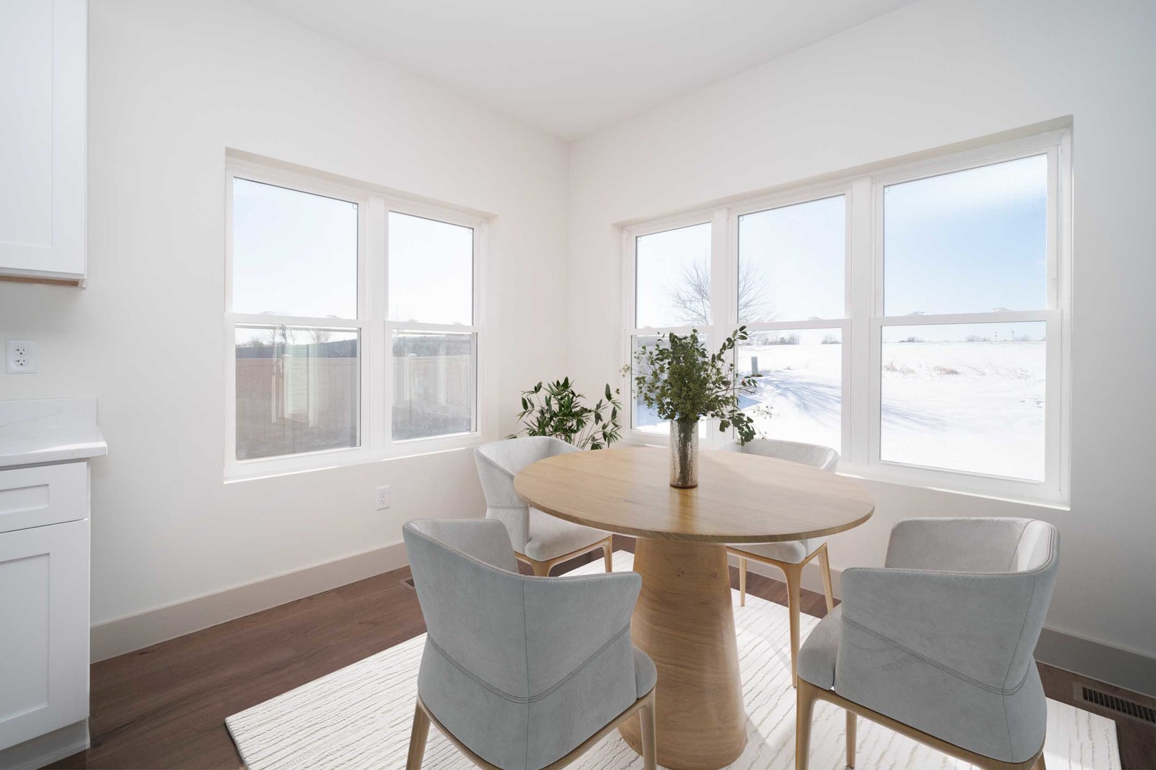 550 Cross Plains Road Rockford, IL 61107 - Photo 15 of 34 a dining room with furniture potted plants and wooden floor