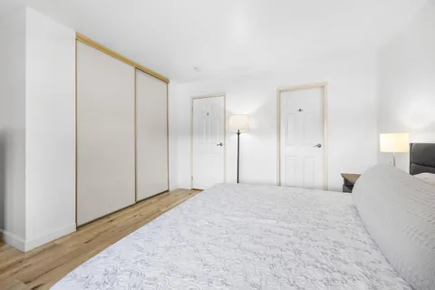 a view of a bedroom with closet and bathroom