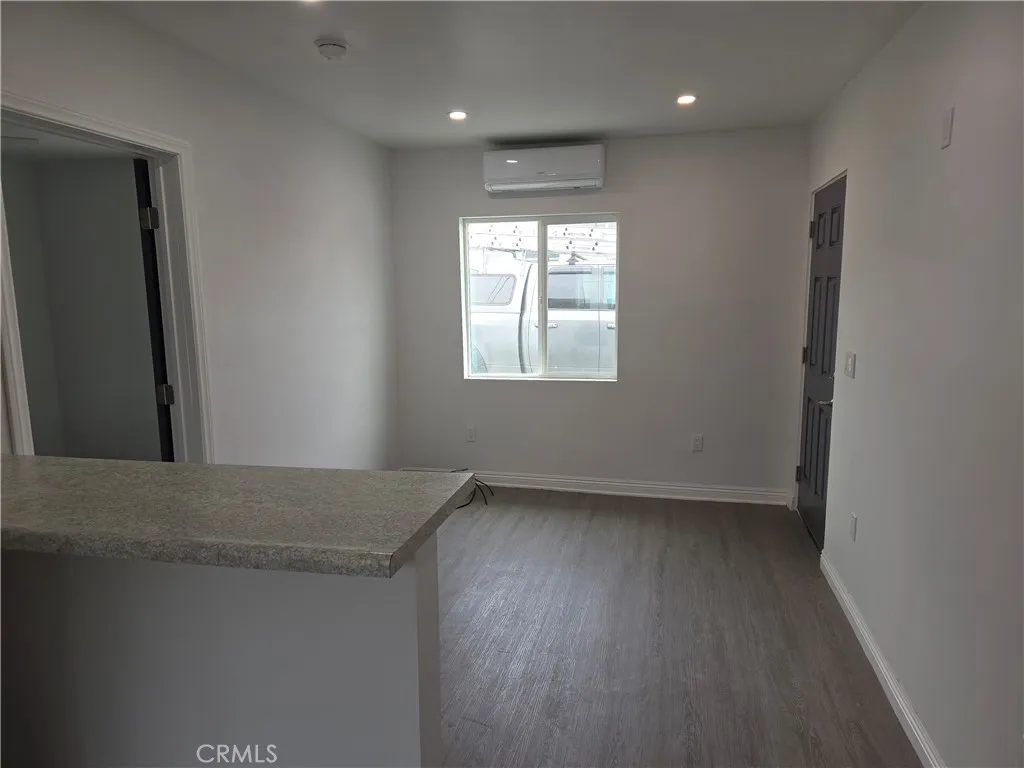 5417 Baltimore Street Los Angeles, CA 90042 - Photo 4 of 9 an empty room with wooden floor and windows