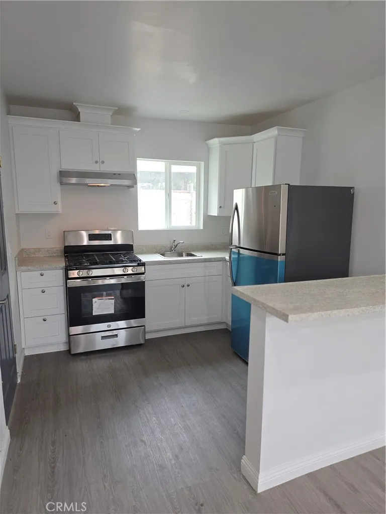 5417 Baltimore Street Los Angeles, CA 90042 - Photo 5 of 9 a kitchen with stainless steel appliances a stove a sink and a refrigerator