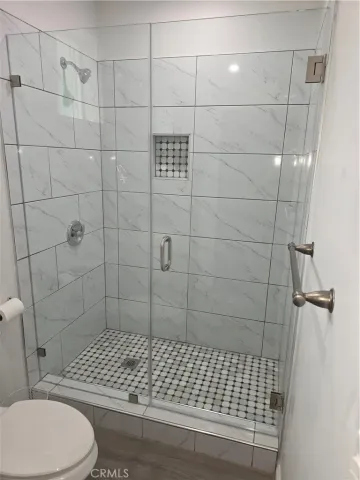 a bathroom with a toilet and a shower