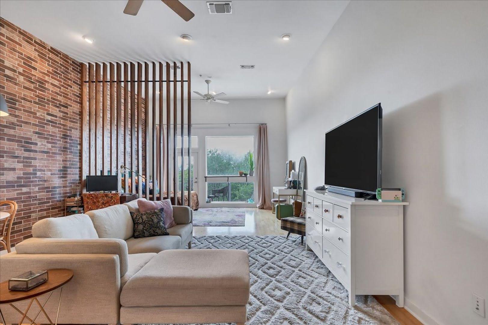 2931 East 12th Street, Unit 306 Austin, TX 78702 - Photo 11 of 19 a living room with furniture and a flat screen tv