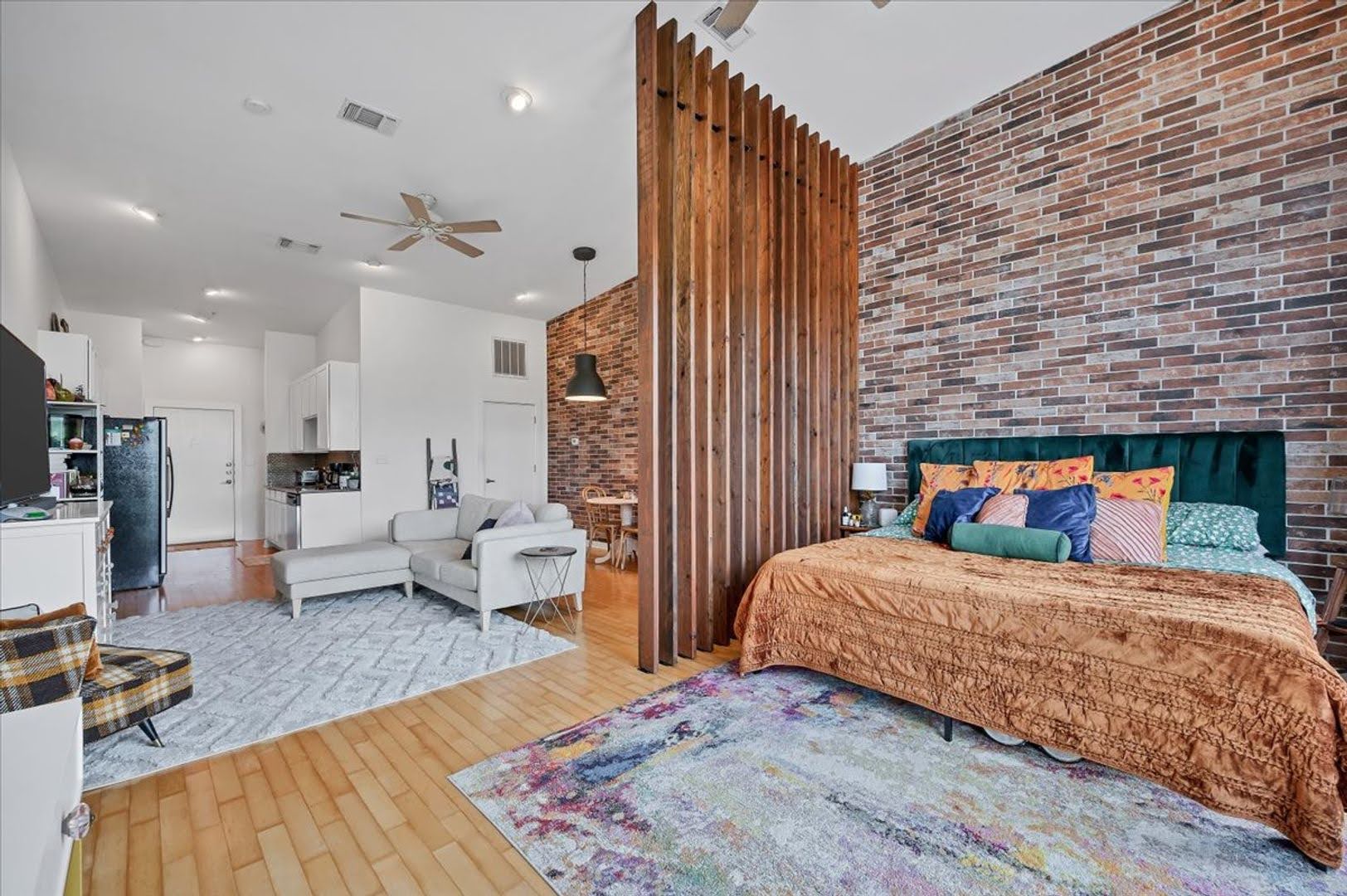 2931 East 12th Street, Unit 306 Austin, TX 78702 - Photo 16 of 19 a bedroom with a bed couch and a view of living room