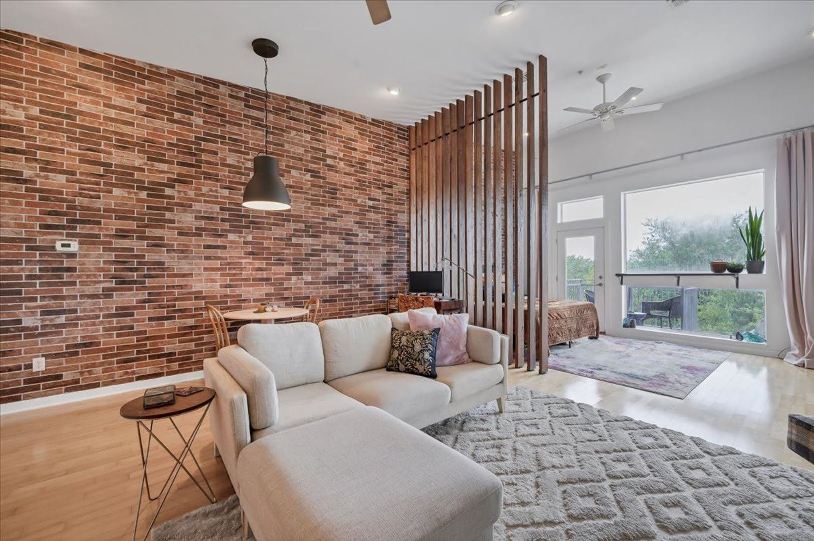 2931 East 12th Street, Unit 306 Austin, TX 78702 - Photo 10 of 19 a living room with furniture and a floor to ceiling window