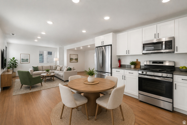 70 East Weekes Way Clearfield, UT 84015 - Photo 3 of 25 Spacious open-concept living area featuring wood-finish flooring and recessed lighting