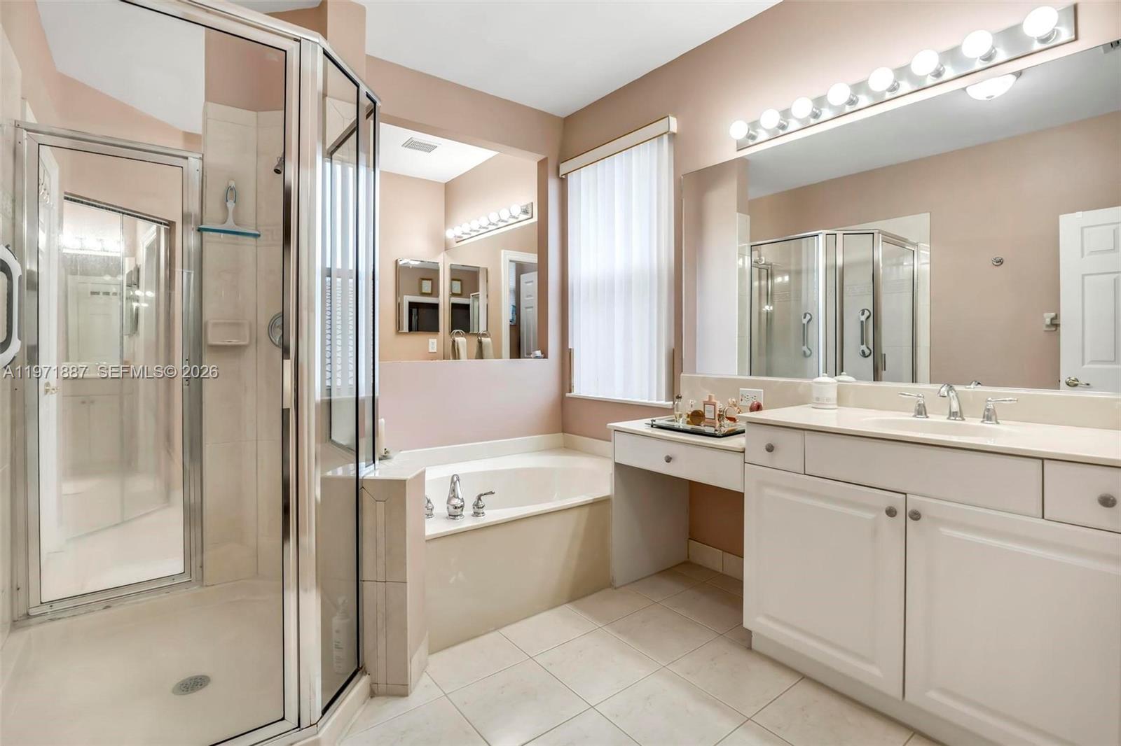 5321 Southwest 184th Way Miramar, FL 33029 - Photo 22 of 43 a bathroom with a double vanity sink mirror and shower