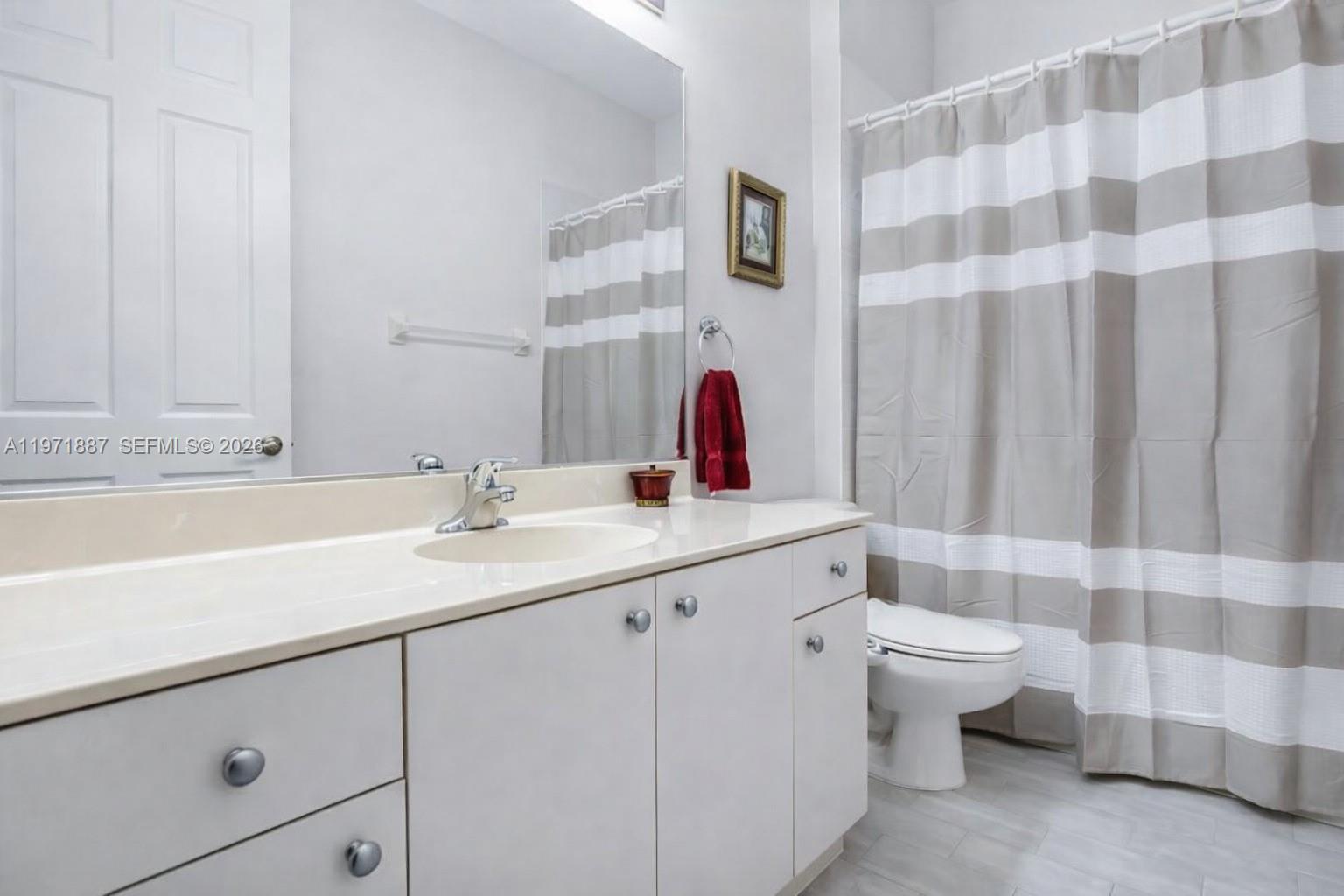 5321 Southwest 184th Way Miramar, FL 33029 - Photo 25 of 43 a bathroom with a double vanity sink mirror and toilet