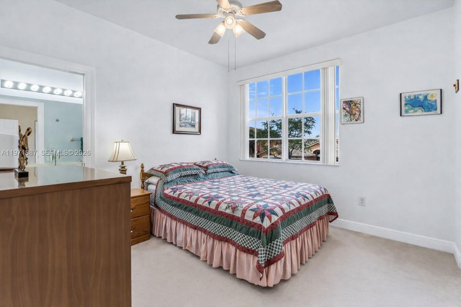 5321 Southwest 184th Way Miramar, FL 33029 - Photo 26 of 43 a bedroom with a bed and a chandelier
