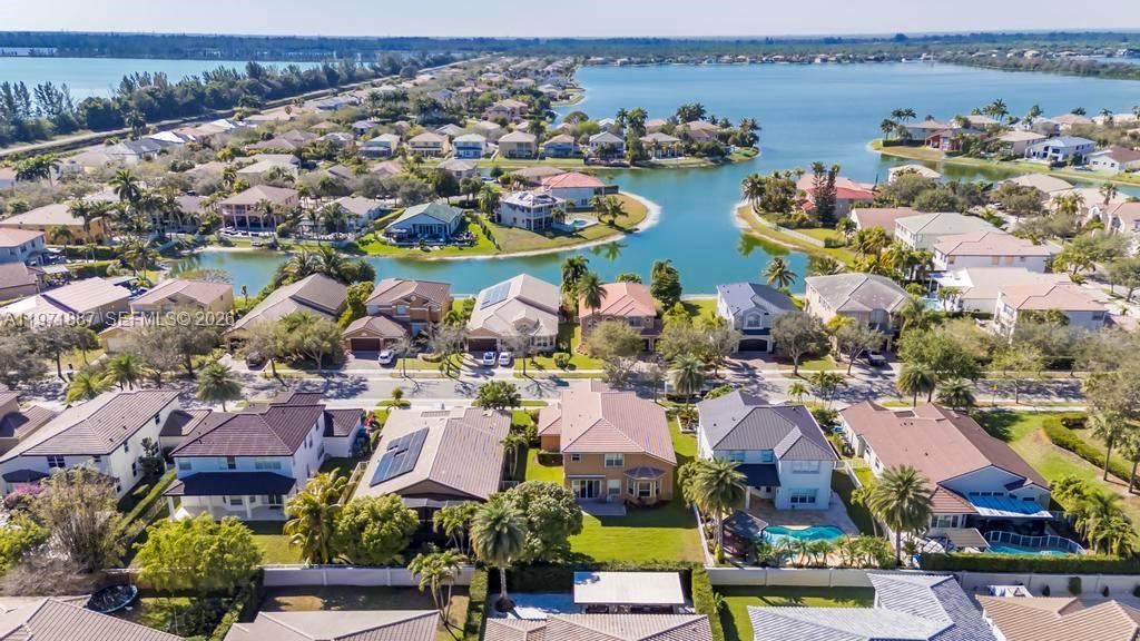 5321 Southwest 184th Way Miramar, FL 33029 - Photo 38 of 43 an aerial view of a city with lots of residential buildings ocean and mountain view in back