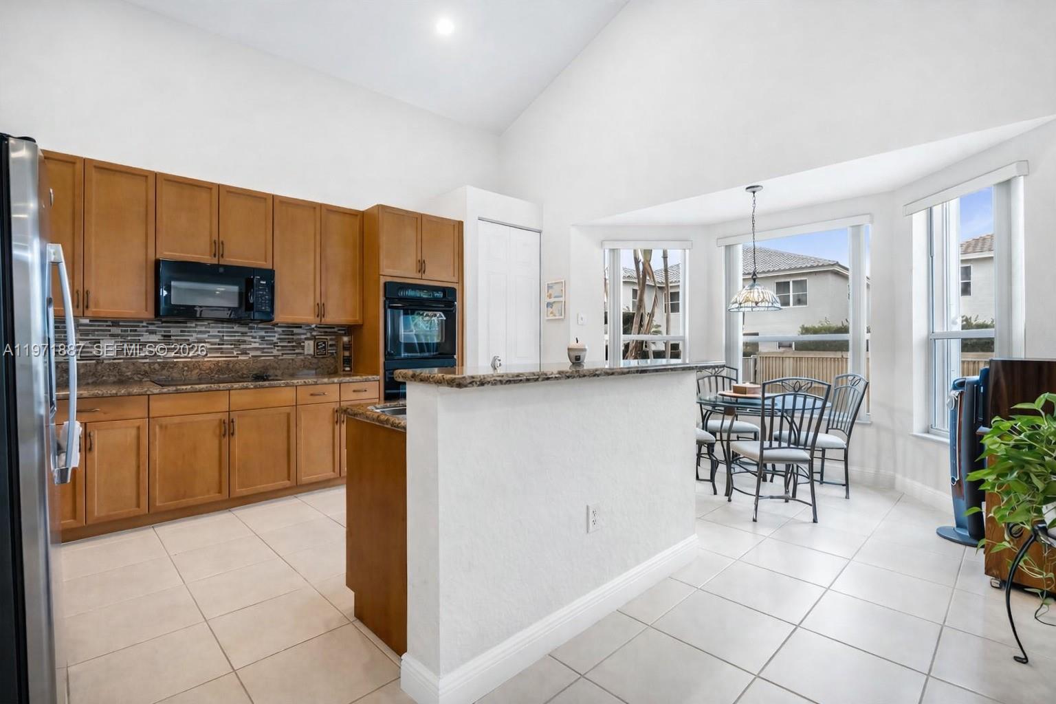 5321 Southwest 184th Way Miramar, FL 33029 - Photo 5 of 43 a kitchen with stainless steel appliances a refrigerator sink and cabinets
