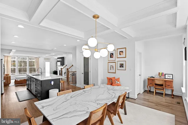 a view of a dining room with furniture and a chandelier