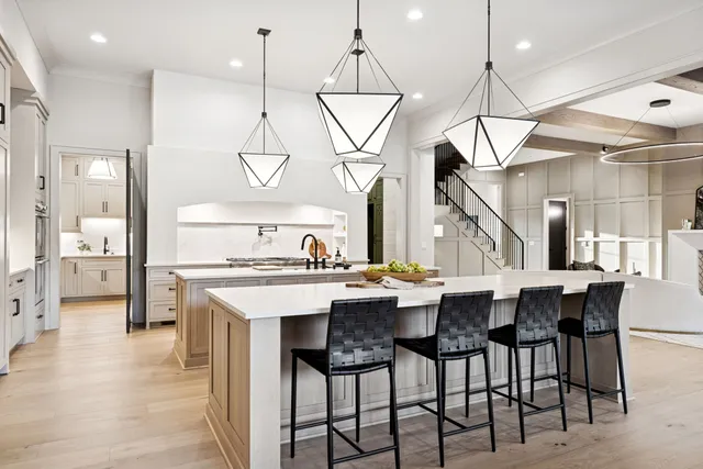 a very nice looking dining room with a large window and chandelier